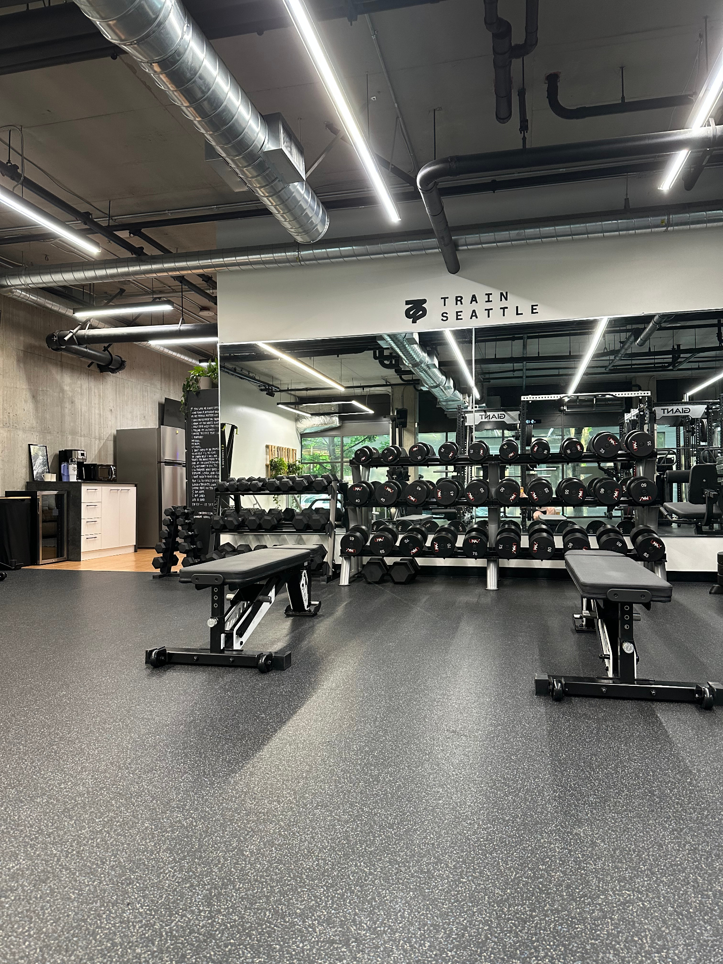Free weights area and mirrored wall inside TRAIN Seattle